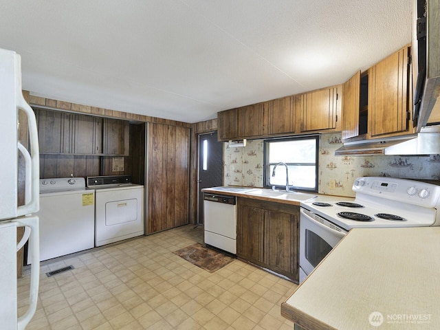 20725 9th Ave E Unit 6, Spanaway, WA 98387 - kitchen with white appliances, washing machine and dryer, light flooring, and light countertops