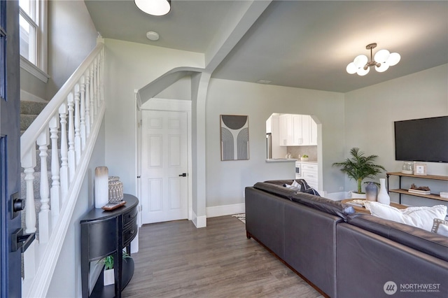 3225 Oakes Ave, Everett, WA 98201 - living area with arched walkways, a chandelier, stairs, and dark wood finished floors