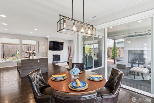 12914 SE 213th, Kent, WA 98031 - dining area featuring a fireplace, dark wood finished floors, and recessed lighting