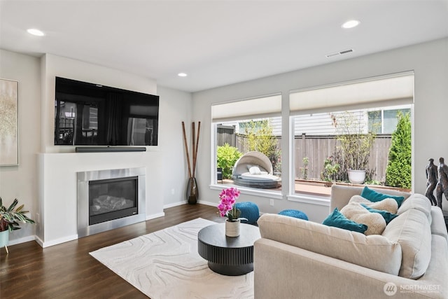12914 SE 213th, Kent, WA 98031 - living room featuring plenty of natural light, wood finished floors, recessed lighting, and a glass covered fireplace