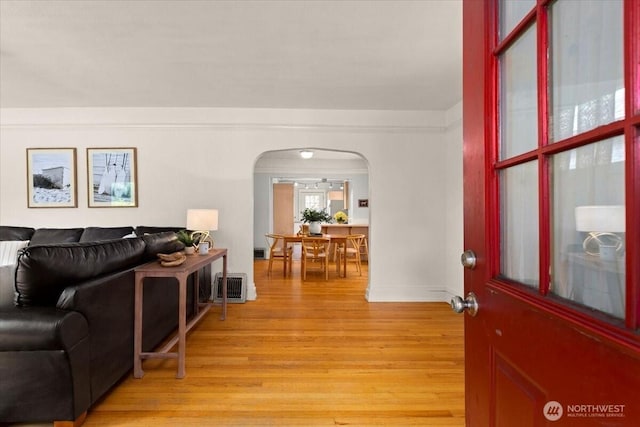 1305 N 6th St, Tacoma, WA 98403 - living area with arched walkways and light wood-style floors