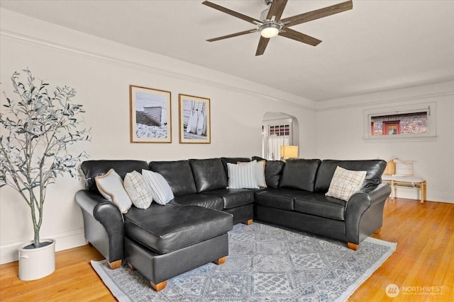 1305 N 6th St, Tacoma, WA 98403 - living room with arched walkways, a ceiling fan, and wood finished floors