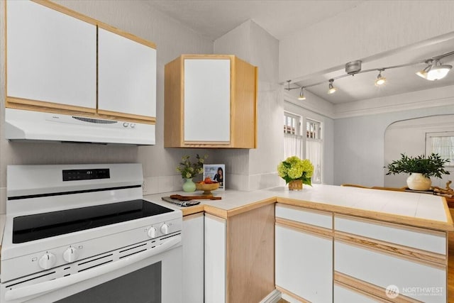 1305 N 6th St, Tacoma, WA 98403 - kitchen with electric stove, exhaust hood, a peninsula, track lighting, and white cabinetry
