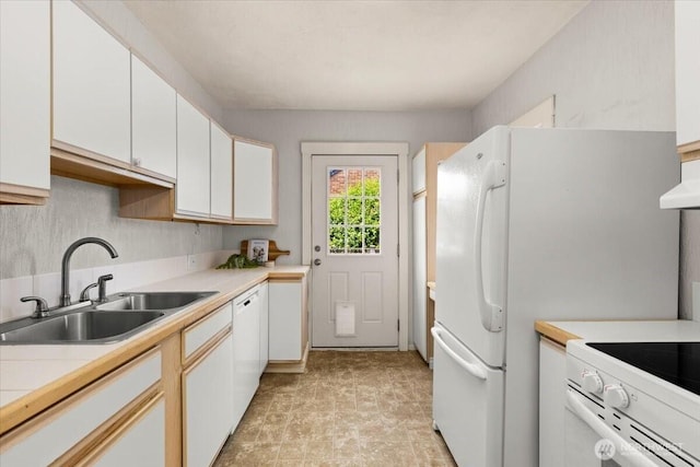 1305 N 6th St, Tacoma, WA 98403 - kitchen with white cabinets, white appliances, wall chimney exhaust hood, and stone finish floors