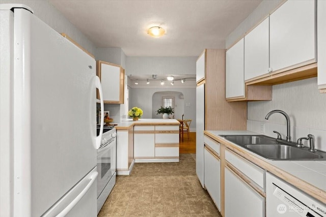 1305 N 6th St, Tacoma, WA 98403 - kitchen featuring white appliances, light countertops, white cabinetry, and a peninsula