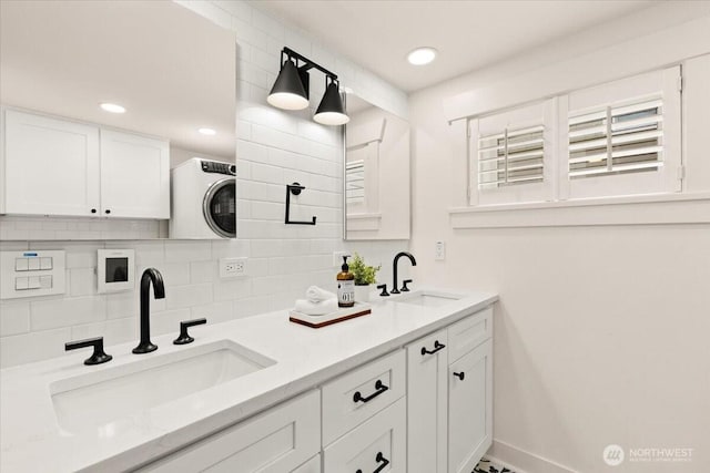 1305 N 6th St, Tacoma, WA 98403 - full bathroom with decorative backsplash, double vanity, washer / clothes dryer, and recessed lighting