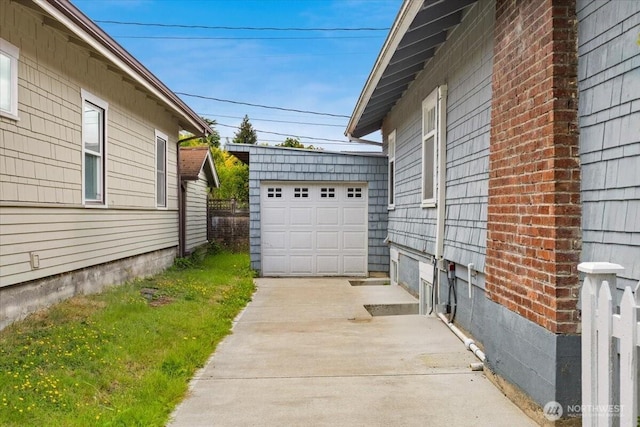 1305 N 6th St, Tacoma, WA 98403 - view of side of property with concrete driveway and a detached garage