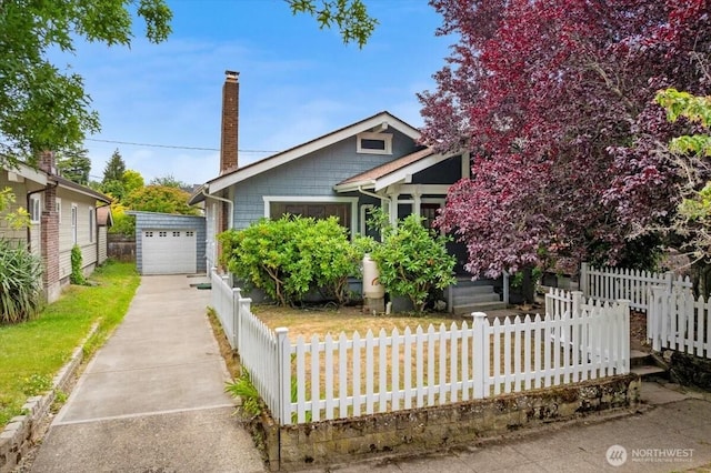 1305 N 6th St, Tacoma, WA 98403 - view of front of home with driveway, a fenced front yard, a chimney, and an outdoor structure