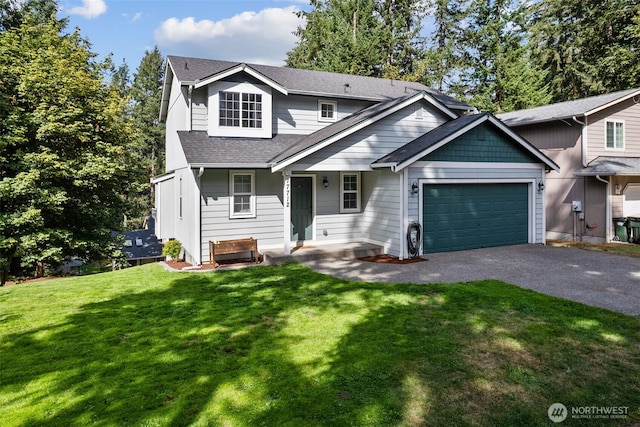 17712 E Clear Lake Blvd SE, Yelm, WA 98597 - view of front of home with an attached garage, asphalt driveway, a front yard, and a shingled roof
