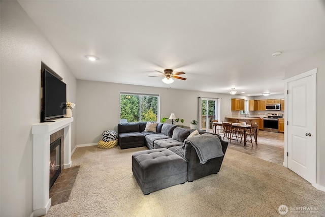 17712 E Clear Lake Blvd SE, Yelm, WA 98597 - living room featuring a ceiling fan, a tile fireplace, and light carpet