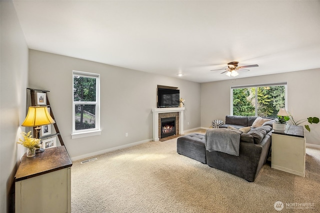 17712 E Clear Lake Blvd SE, Yelm, WA 98597 - living room featuring healthy amount of natural light, a ceiling fan, a tiled fireplace, and carpet floors