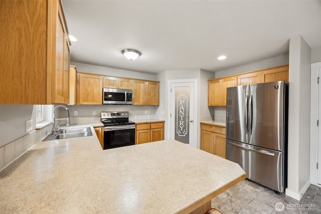17712 E Clear Lake Blvd SE, Yelm, WA 98597 - kitchen with stainless steel appliances, a peninsula, light countertops, recessed lighting, and light brown cabinetry