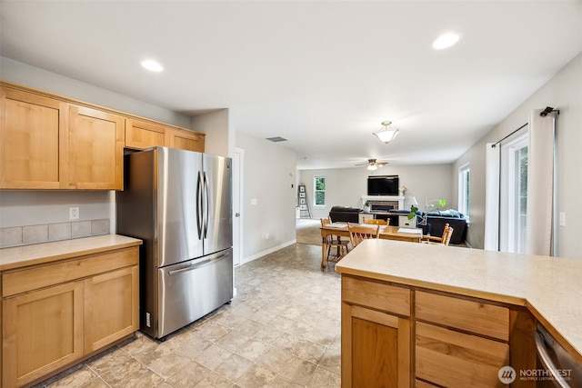 17712 E Clear Lake Blvd SE, Yelm, WA 98597 - kitchen with freestanding refrigerator, a fireplace, a ceiling fan, light countertops, and recessed lighting