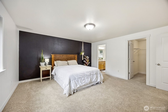 17712 E Clear Lake Blvd SE, Yelm, WA 98597 - bedroom featuring light colored carpet, a spacious closet, ensuite bath, and an accent wall