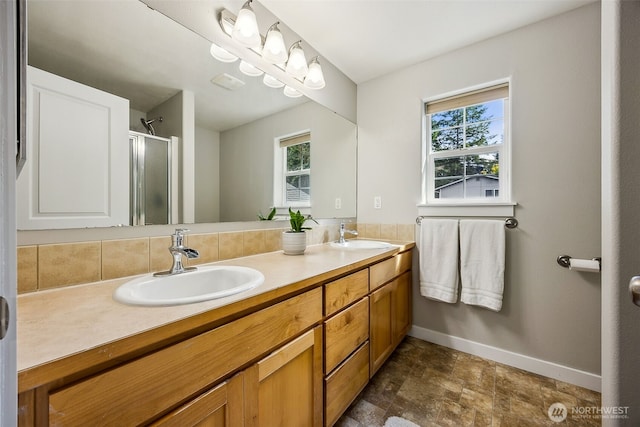 17712 E Clear Lake Blvd SE, Yelm, WA 98597 - bathroom featuring double vanity, a shower stall, healthy amount of natural light, and stone finish flooring
