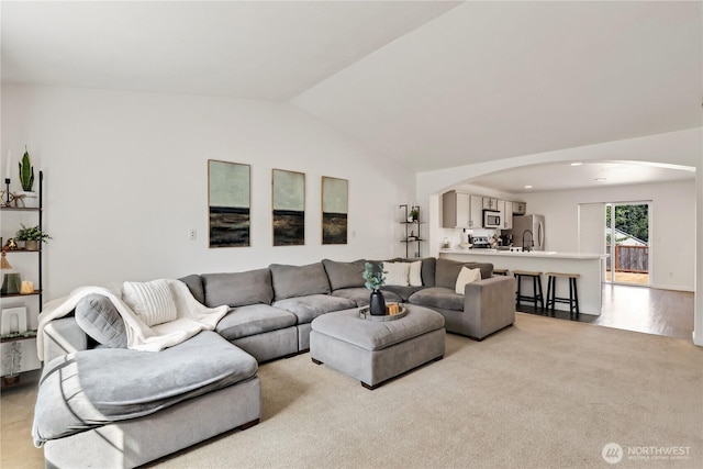 20008 99th Ave E, Graham, WA 98338 - living room with arched walkways, vaulted ceiling, and light colored carpet