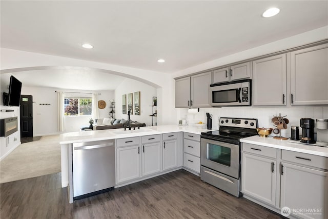 20008 99th Ave E, Graham, WA 98338 - kitchen with stainless steel appliances, gray cabinets, open floor plan, arched walkways, and recessed lighting