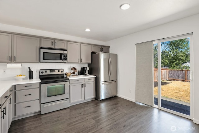 20008 99th Ave E, Graham, WA 98338 - kitchen featuring appliances with stainless steel finishes, gray cabinetry, light countertops, recessed lighting, and dark wood finished floors
