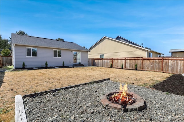 20008 99th Ave E, Graham, WA 98338 - back of property with an outdoor fire pit and a fenced backyard