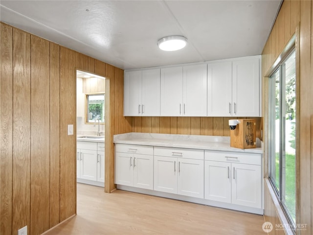9128 184th Ave NE, Granite Falls, WA 98252 - kitchen with wooden walls, light countertops, white cabinets, and light wood finished floors