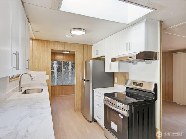 9128 184th Ave NE, Granite Falls, WA 98252 - kitchen with appliances with stainless steel finishes, under cabinet range hood, white cabinetry, decorative backsplash, and light stone counters