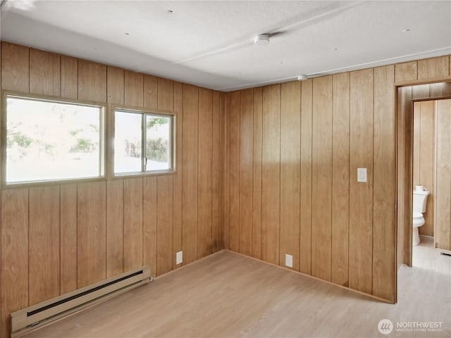 9128 184th Ave NE, Granite Falls, WA 98252 - empty room with baseboard heating, wood finished floors, and wooden walls