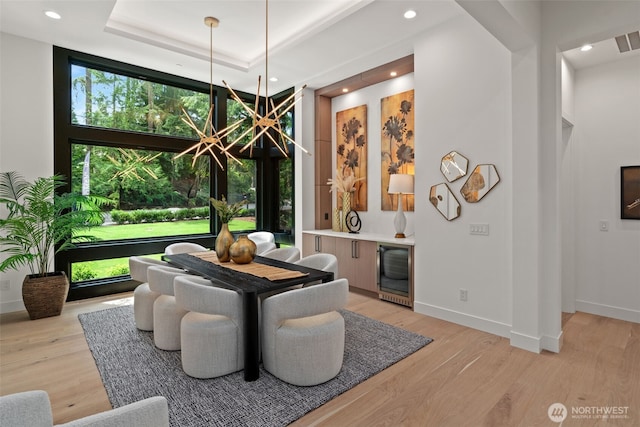 10230 SE 13th Pl, Bellevue, WA 98004 - dining room featuring wine cooler, light wood-style flooring, recessed lighting, a high ceiling, and a raised ceiling