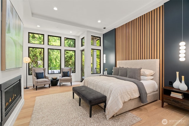 10230 SE 13th Pl, Bellevue, WA 98004 - bedroom with recessed lighting, a glass covered fireplace, and wood finished floors