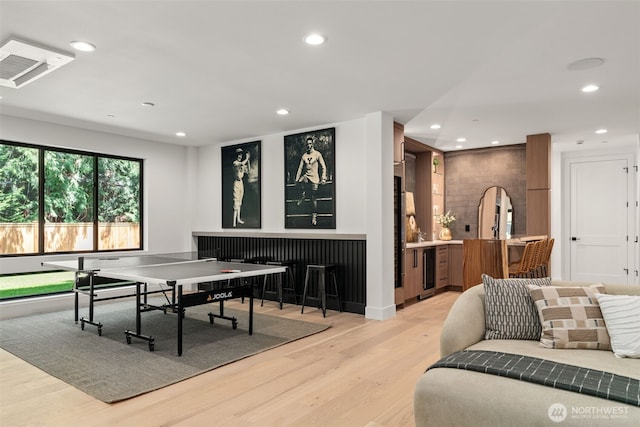 10230 SE 13th Pl, Bellevue, WA 98004 - rec room featuring light wood-type flooring, recessed lighting, bar area, beverage cooler, and arched walkways