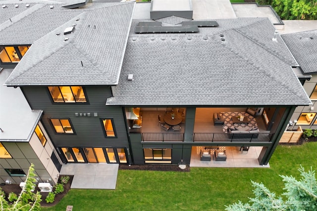 10230 SE 13th Pl, Bellevue, WA 98004 - back of house with a shingled roof, roof mounted solar panels, a yard, and a patio