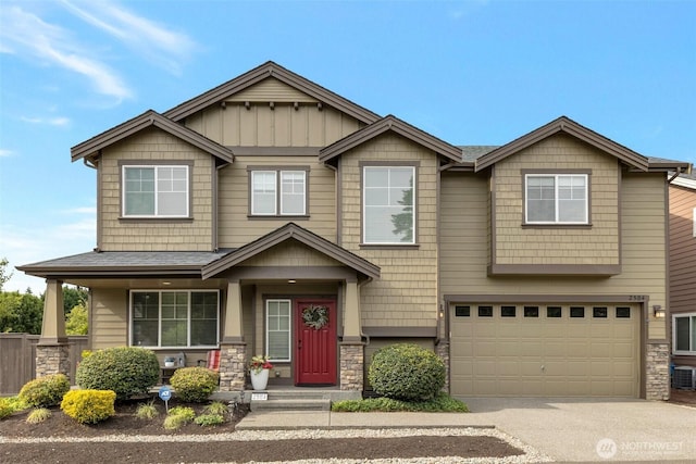 2504 NE 24th Pl, Renton, WA 98056 - craftsman-style house with stone siding, driveway, a garage, and board and batten siding