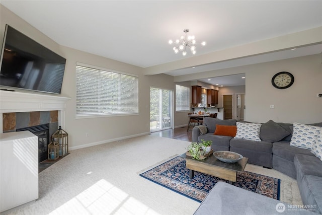 2504 NE 24th Pl, Renton, WA 98056 - living area with a tiled fireplace, a chandelier, and carpet floors