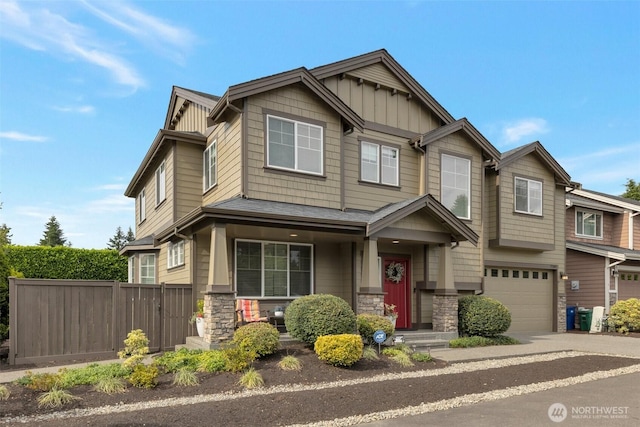 2504 NE 24th Pl, Renton, WA 98056 - craftsman-style house featuring stone siding, concrete driveway, an attached garage, and board and batten siding