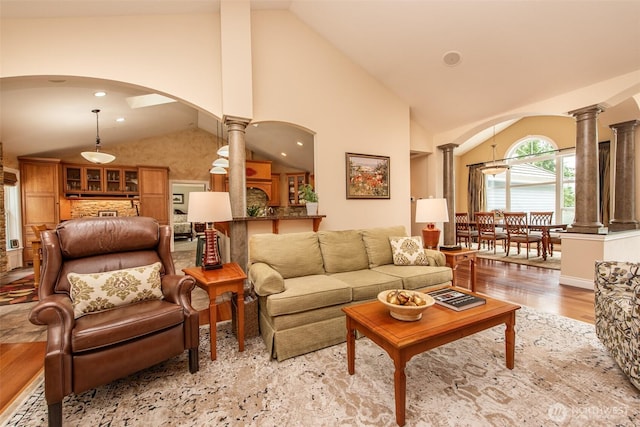 1483 Fox Hollow Rd, Sequim, WA 98382 - living area featuring ornate columns, arched walkways, wood finished floors, high vaulted ceiling, and recessed lighting