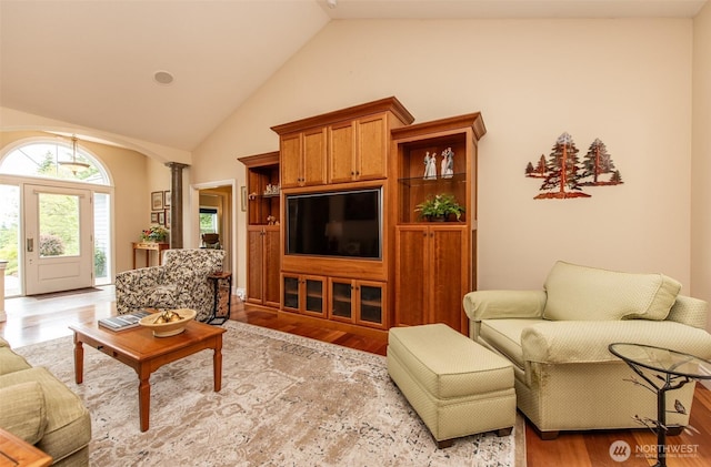 1483 Fox Hollow Rd, Sequim, WA 98382 - living room with ornate columns, wood finished floors, and high vaulted ceiling