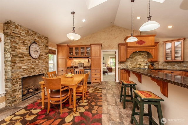 1483 Fox Hollow Rd, Sequim, WA 98382 - dining area featuring a skylight, high vaulted ceiling, a fireplace, and recessed lighting