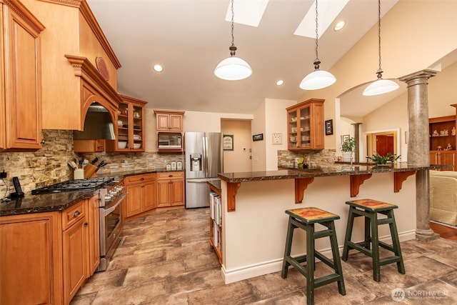 1483 Fox Hollow Rd, Sequim, WA 98382 - kitchen with appliances with stainless steel finishes, a kitchen breakfast bar, tasteful backsplash, a skylight, and vaulted ceiling