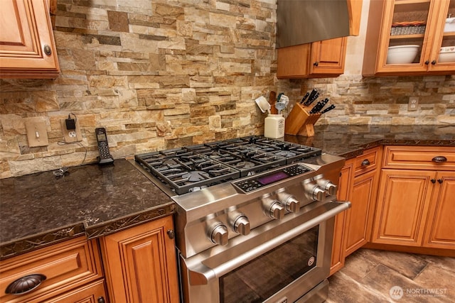 1483 Fox Hollow Rd, Sequim, WA 98382 - kitchen featuring stainless steel stove, decorative backsplash, brown cabinets, and glass insert cabinets