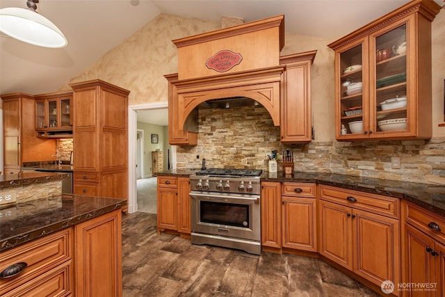 1483 Fox Hollow Rd, Sequim, WA 98382 - kitchen featuring high end range, lofted ceiling, decorative backsplash, dark stone countertops, and brown cabinets