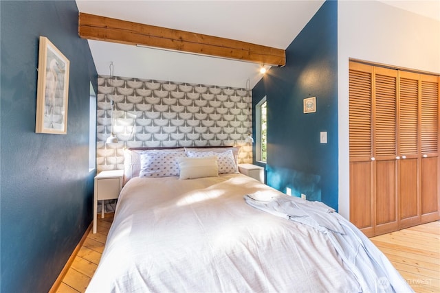 251 Saddle Dr, Port Townsend, WA 98368 - bedroom with wood-type flooring, beam ceiling, and a closet
