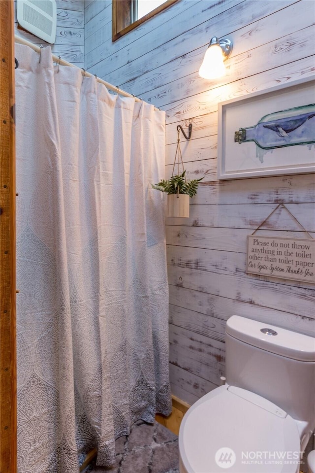 251 Saddle Dr, Port Townsend, WA 98368 - bathroom featuring wooden walls and a shower with curtain