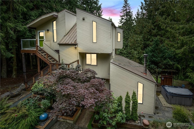 251 Saddle Dr, Port Townsend, WA 98368 - property exterior at dusk with a hot tub, stairway, and a metal roof