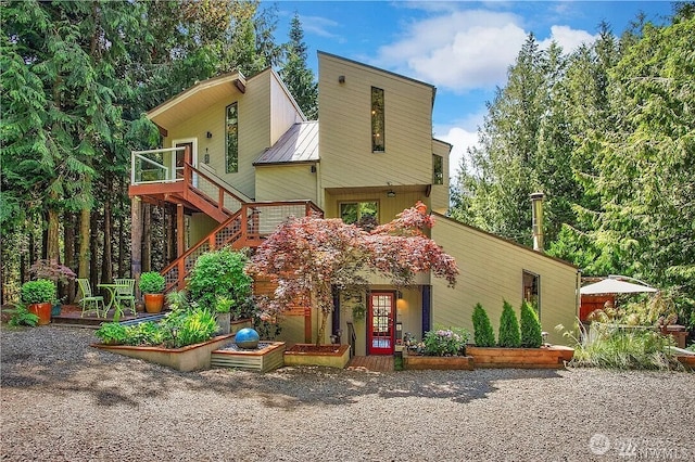 251 Saddle Dr, Port Townsend, WA 98368 - mid-century modern home featuring a metal roof, a vegetable garden, and a wooden deck