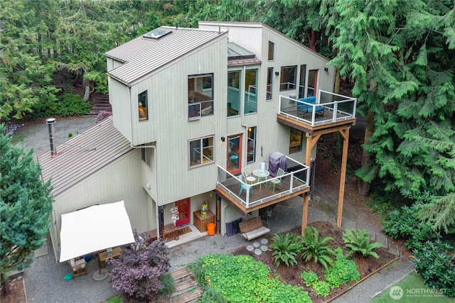 251 Saddle Dr, Port Townsend, WA 98368 - back of property with a metal roof, stairway, and a balcony