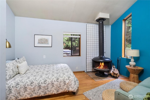 251 Saddle Dr, Port Townsend, WA 98368 - bedroom with wood finished floors and a wood stove
