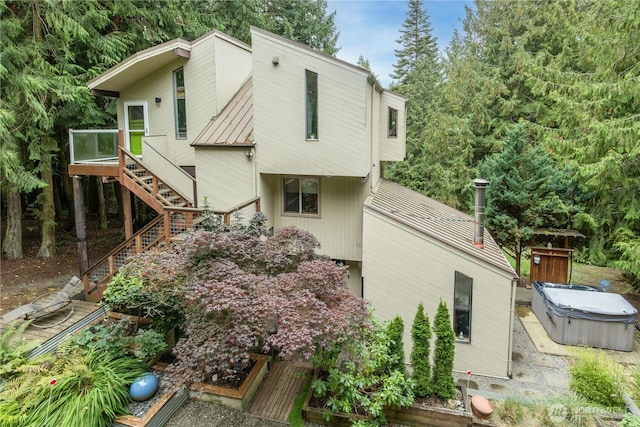 251 Saddle Dr, Port Townsend, WA 98368 - back of property with a hot tub, stairway, a metal roof, and a wooden deck