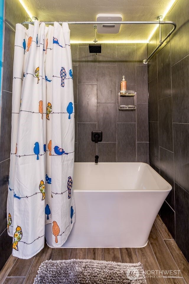 251 Saddle Dr, Port Townsend, WA 98368 - bathroom with wood finished floors and a combined bath / shower with rainfall shower