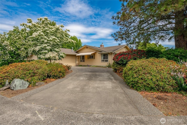 1021 Garden Dr, Lynden, WA 98264 - view of front of house featuring driveway, a garage, and a chimney