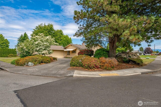1021 Garden Dr, Lynden, WA 98264 - view of property hidden behind natural elements with driveway and an attached garage