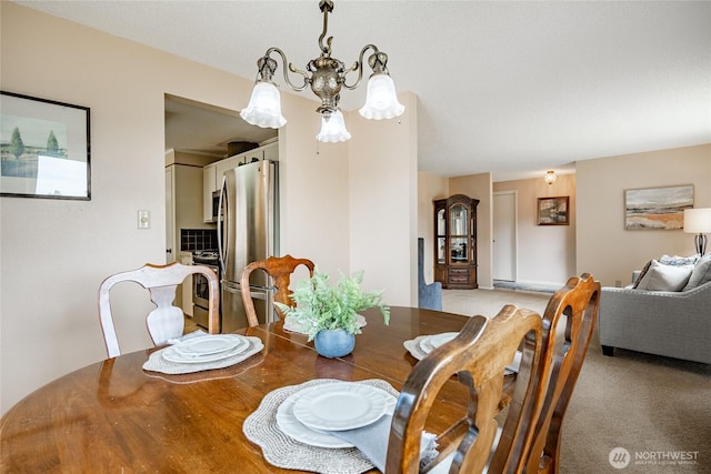 1021 Garden Dr, Lynden, WA 98264 - dining area featuring a chandelier and light colored carpet